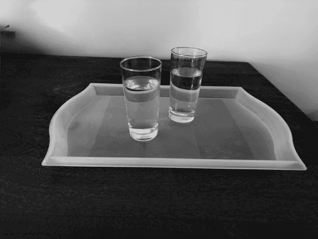 Two glasses of water carried on a tray