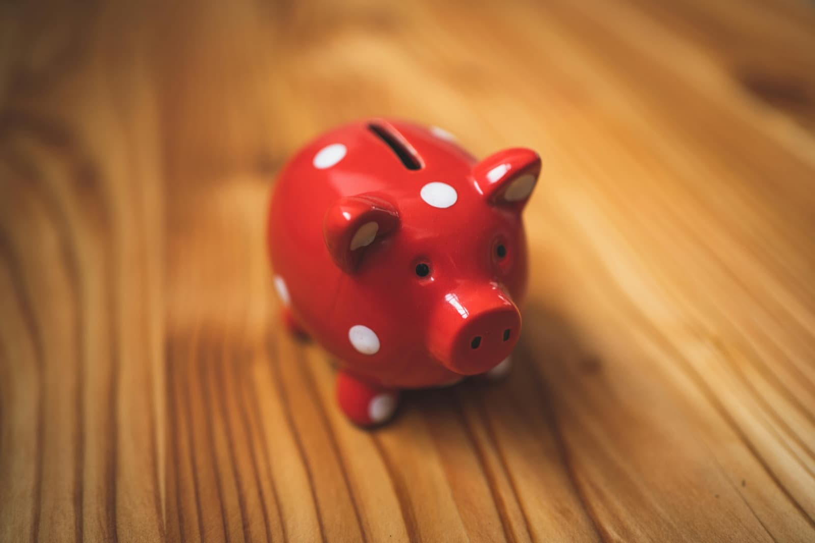 A piggy bank with coins beside it
